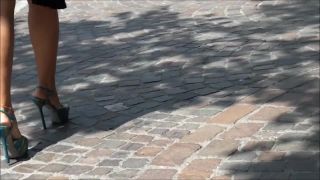 Outdoors candid film of a woman with sexy legs and feet in platform high heels walking around and sitting on a bench to rest her feet.-0