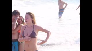 Busty ginger girl enjoys big waves in the water-1