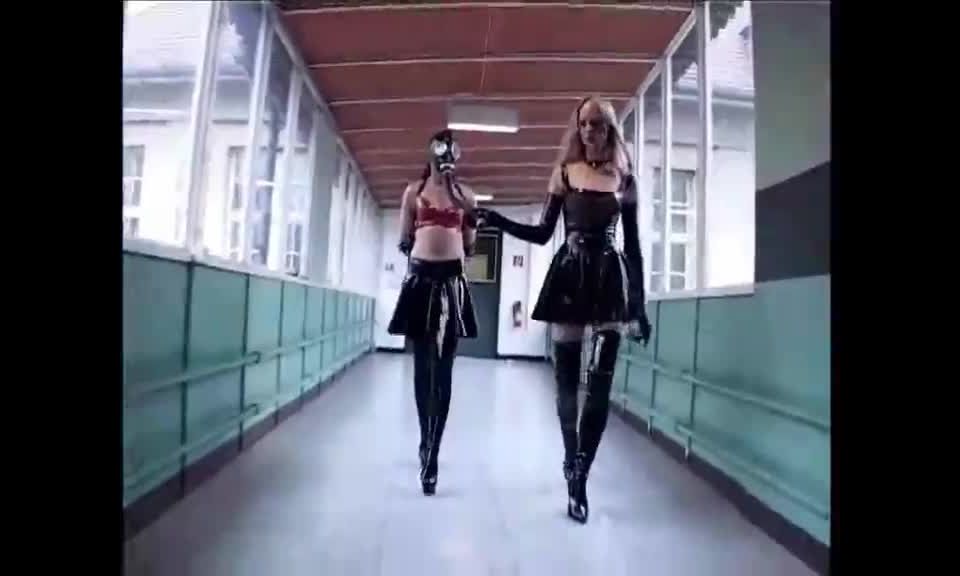 Latex Mistresses. Two latex Mistresses train their latex female slaves with crops and pony training